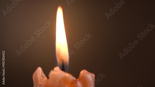Candle flame close up on a dark background. Candle light border design. Melted wax One Candle burning at night. Rotating candles burning in the dark. Candlelight. Religion, hope concept 