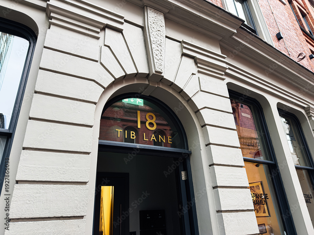 Naklejka premium Historic arched doorway at 18 Tib Lane in Manchester, UK, a classic building detail