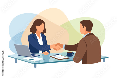 Business partners shaking hands across a desk during a meeting.