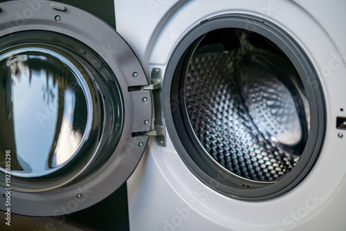 Open front loading washing machine with metal drum