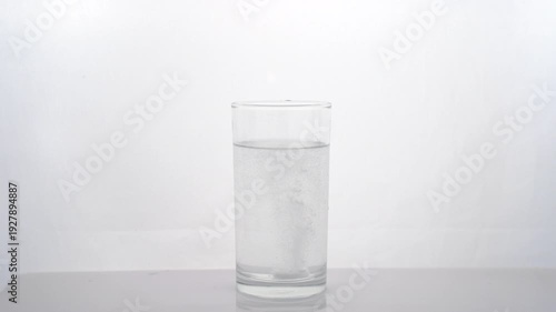 Slow-motion close-up of effervescent medicine tablets dissolving in water, helping to reduce phlegm and viscosity to support throat health with acetylcysteine action.4k video
