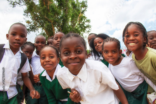 Happy black African kids in school uniforms smiling and enjoying