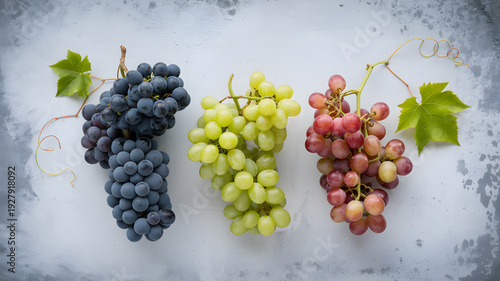 A vibrant display of three bunches of grapes on a white surface