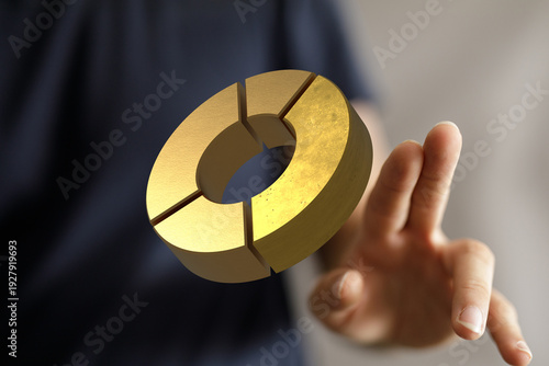 Hand holding golden donut c...