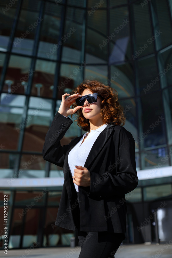Fototapeta premium Happy Businesswoman Portrait With Sunglasses In Urban Corporate Setting