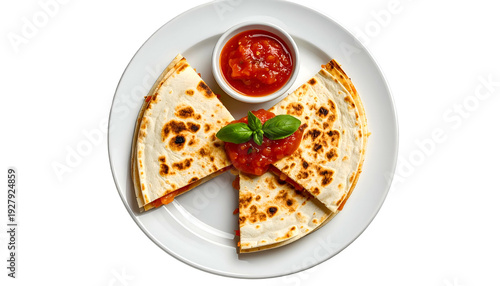 Overhead shot of cut quesadilla slices with salsa in a small bowl on a white plate