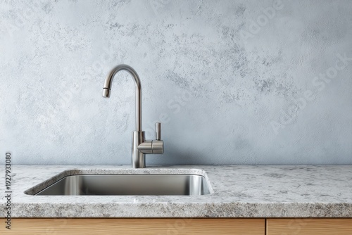 Modern kitchen faucet with granite countertop and textured wall.