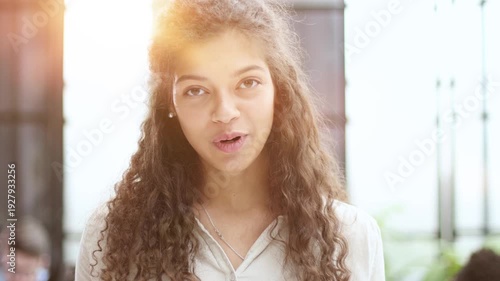 Front portrait of pretty young woman in office