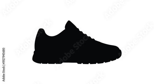 Black running shoe presented in a stark dramatic silhouette
