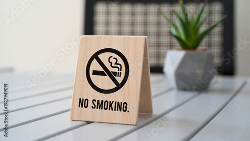 Wooden No smoking sign on table with prohibition symbol, smoke-free policy and public health concept.