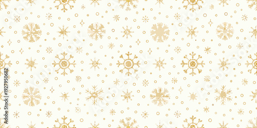 Golden snowflakes scattered across a soft cream colored background