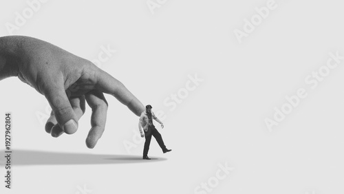 Tableau sur toile Conceptual mixed media giant hand manipulating small human figure