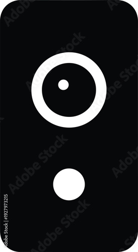 A simple black and white illustration of a camera lens with a circular aperture and a smaller dot below it, representing photography equipment