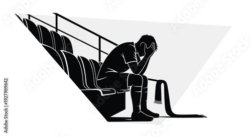 A dejected soccer player in silhouette sits alone on a stadium bench with his head in his hands, a team scarf lying beside him after a devastating loss.