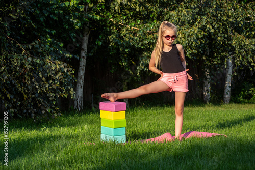 A young gymnast trains outdoors.