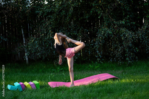 A young gymnast trains outdoors.