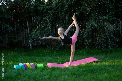 A young gymnast trains outdoors.