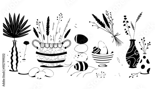 Elegant black and white vase arrangement with plants and flowers