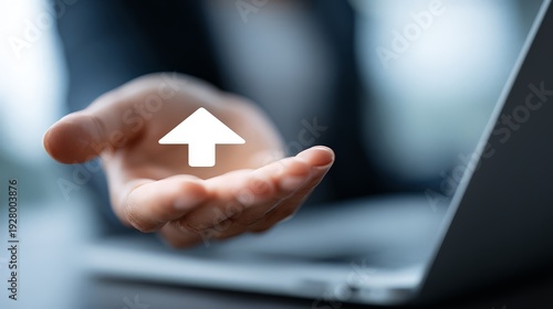 Wallpaper Mural A person's open palm extended over a sleek laptop, with a white, upward-pointing arrow icon floating just over the hand, represents offering, supporting, or holding the key to success. Torontodigital.ca