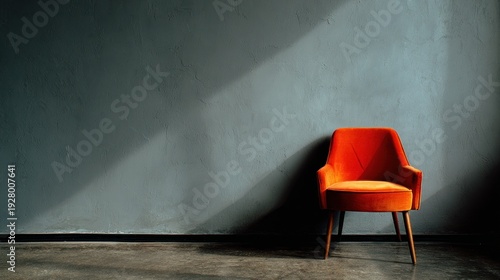 Cozy chair sits by a gray wall in a room, leaving space for messages.