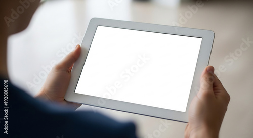 Wallpaper Mural Bright tablet screen held intently for clear vision. Torontodigital.ca