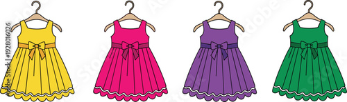 Set of colorful girls summer dresses hanging on wooden hangers with bows and pleated skirts for kids fashion retail and clothing concept