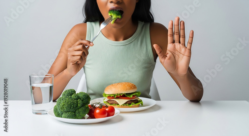 Wallpaper Mural Woman eats broccoli but dislikes burger dramatically Torontodigital.ca