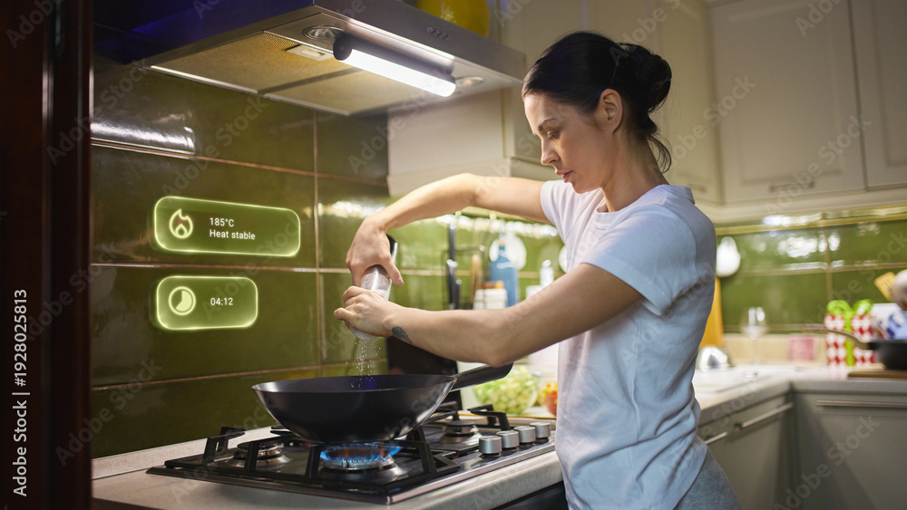 © Lustre Art Group  - Woman cooking on smart gas stove with holographic temperature control interface. Concept of smart kitchen technology, home automation and connected cooking appliances.