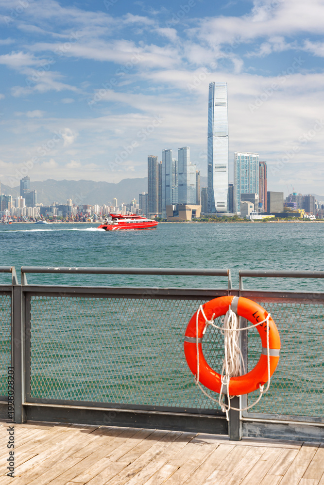 Fototapeta premium Hong Kong skyscraper panorama on a sunny day with water and boats
