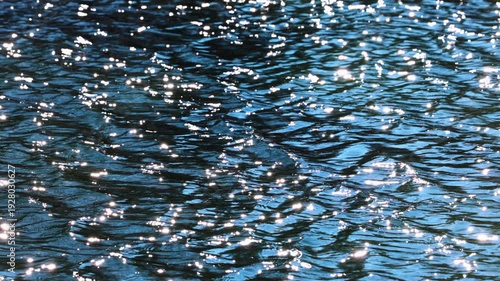 4k with the sheen of water with small waves reflecting the sun