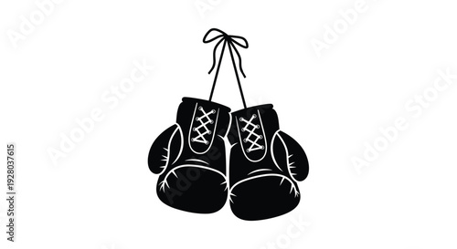 A pair of black boxing gloves hangs suspended by their tied laces.