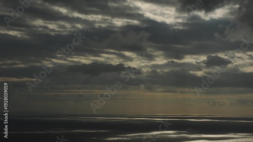 4K timelapse of moving clouds and shifting sunlight reflections over Aegean Sea, Cyclades Greece