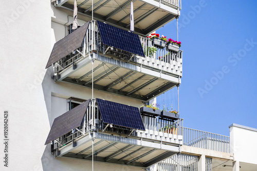 Modern Balcony with Solar Panels Mini Station. Solar Panel Mounting Balcony Railing. Solar Energy System for Apartment Building. Mini Solar system for Apartment. Renewable Energy in City Apartment.