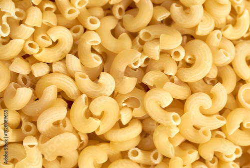 Macaroni dry pasta background concept. Pasta texture for background uses. Swirled pasta pattern. Food photography in studio.