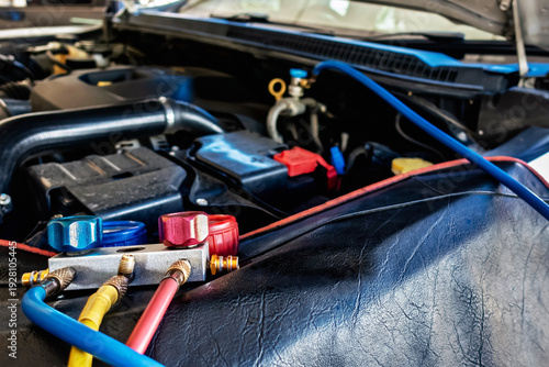 A/C Manifold Gauges Set. Check pressure and leak for use air conditioning systems. Recharging car air conditioner with refrigerant using grade gear with separate gauges to monitor pressure in system.