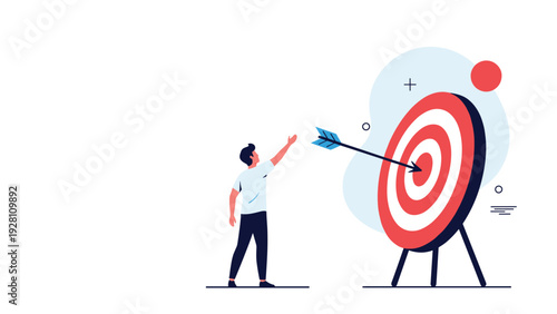 Determined man pointing his hand toward a large target where an arrow has successfully hit the center bullseye of the mark.