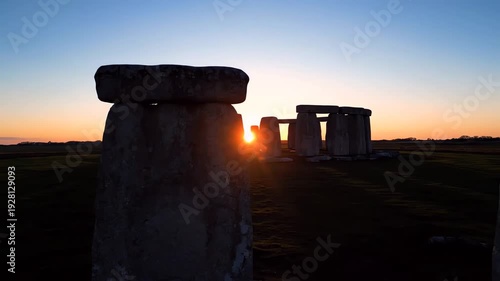 Ancient Monoliths of Stonehenge Silhouetted Against a Vibrant Sunrise over Salisbury Plain Uk Highlighting History and Mystery