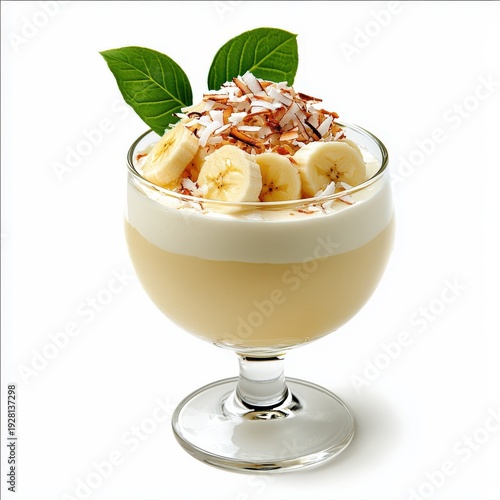 Delicious banana and coconut parfait layered with cream and garnished with fresh leaves and shredded coconut in a clear glass dessert cup