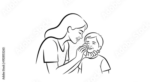 Mother gently wiping her young son's face with care and love.