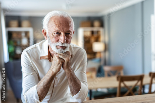 Retirement man and relax portrait with attractive and happy smile resting in house. Senior, elderly and positive men at home enjoying leisure break and pension lifestyle.