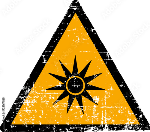 Grunge optical radiation warning sign worn scratched ISO 7010 W027 hazard symbol