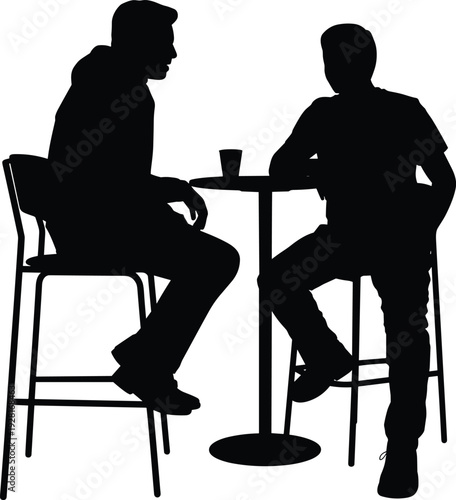 Two men silhouettes talking at cafe table business discussion and informal meeting concept