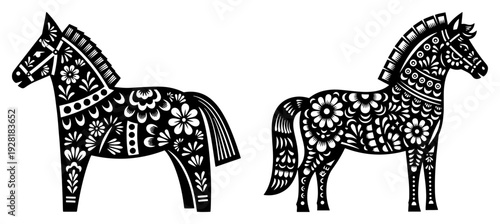 Pair of decorative horses decorated with intricate floral patterns in traditional folk art style