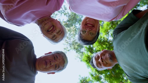 Joyful Group: A low-angle shot captures a heartwarming scene of a diverse group of senior citizens, faces beaming with happiness, looking down with camaraderie and affection.