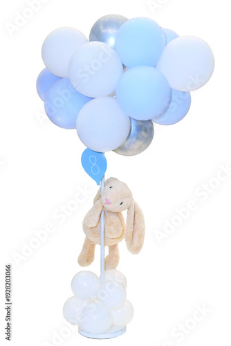 Foto Cute beige plush bunny hanging on blue and white balloons for baby boy shower