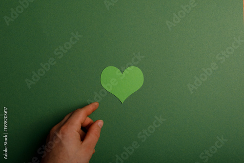 A hand reaching for a green...