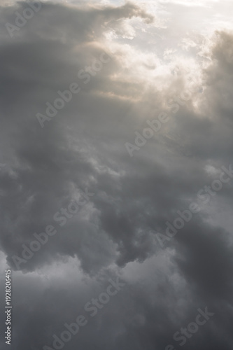 Dramatic sunset sky with dark storm clouds and soft light, moody atmosphere before rainfall