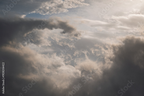 Dramatic sunset sky with dark storm clouds and soft light, moody atmosphere before rainfall