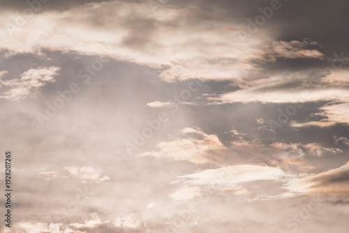 Dramatic sunset sky with dark storm clouds and soft light, moody atmosphere before rainfall