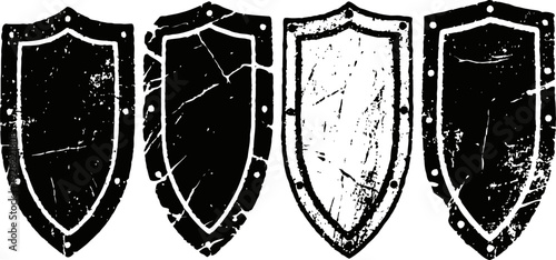 Grunge shield shapes set vintage distressed heraldic emblems with scratches and weathered texture